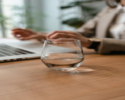 Glass of water on a modern desk